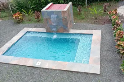 a fountain in the middle of a swimming pool at Casa Palma Real in Playa Junquillal