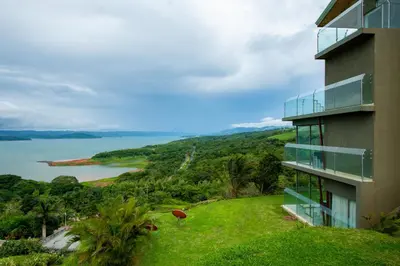 a building with a view of a body of water at Lake Arenal Condos in Naranjos Agrios
