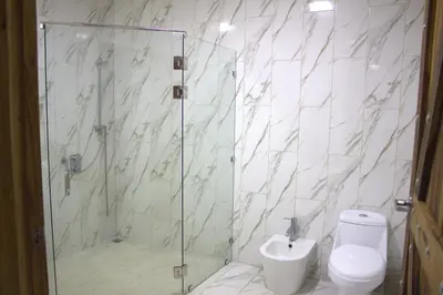 a bathroom with a shower with a toilet and a sink at Home La Fortuna in Fortuna