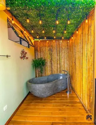 a bath tub in a bathroom with a green ceiling at Modern Mountain View Home by Nauyaca Waterfall in Platanillo