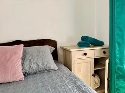 a bedroom with a bed and a wooden night stand at Brisa Amatista - Casa completa y centrica en San Ramón #1 in Palmitos Sur