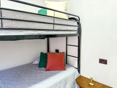a bedroom with two bunk beds with a red pillow at Brisa Amatista - Casa completa y centrica en San Ramón #1 in Palmitos Sur