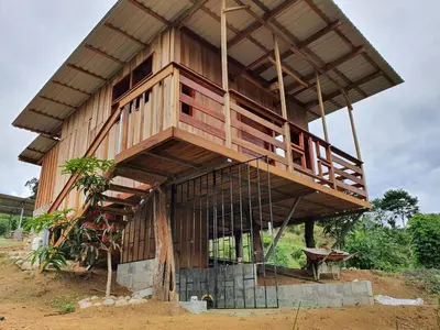 a large wooden building with a balcony on top at Digrú Spaa in Pejibaye