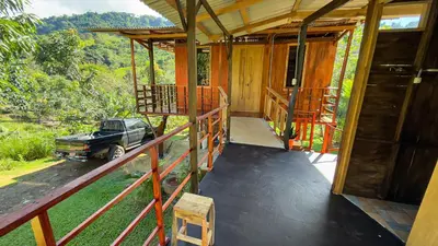 a porch of a house with a car parked in it at Digrú Spaa in Pejibaye