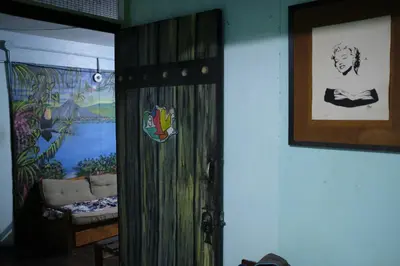 a door in a room with a painting on the wall at Hostal del Este Santa Fe in San José