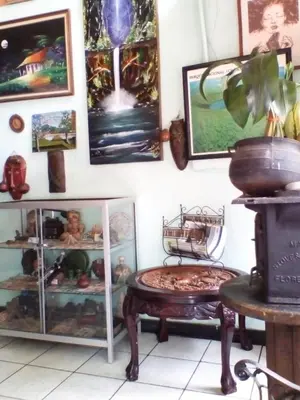 a room with a table and pictures on the wall at Hostal del Este Santa Fe in San José