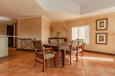 a dining room with a table and chairs at Serene 3BR Condo - Bougainvillea - Reserva Conchal Golf Resort in Playa Conchal