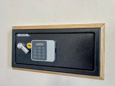 a small tv with a calculator on a wall at Mayoli Hill Deluxe Farmhouse in Fortuna