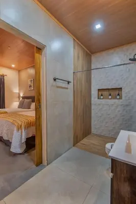 a master bedroom with a bed and a shower at Mayoli Hill Deluxe Farmhouse in Fortuna