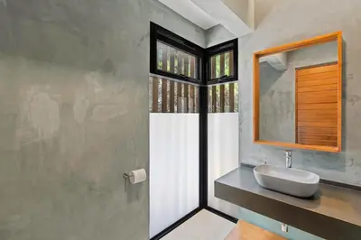 a bathroom with a sink and a mirror at Luxurious Ultramodern Property with Private Suites, Infinity Pool, and Sweeping Ocean and Mountain Views in Potrero