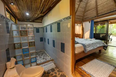 a bathroom with a toilet and a shower at B&B Ranchos Itaúna in Santa Teresa Beach