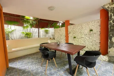 a dining room with a wooden table and chairs at B&B Ranchos Itaúna in Santa Teresa Beach