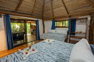 a bedroom with two beds with towels on them at B&B Ranchos Itaúna in Santa Teresa Beach
