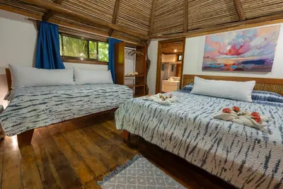 a bedroom with two beds with towels on them at B&B Ranchos Itaúna in Santa Teresa Beach