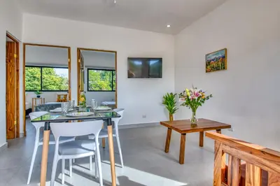 a dining room with a table and chairs at Muna Santa Rosa Apartamentos in Tamarindo