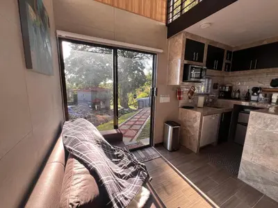 a kitchen with a couch and a large window at Villazul 2 in Poás