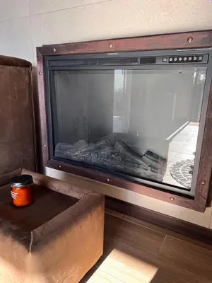 a fireplace in a room with a couch and a table at Villazul 2 in Poás