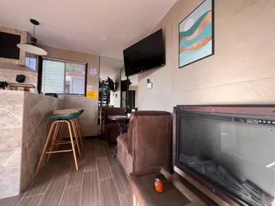 a living room with a large flat screen tv and a living room at Villazul 2 in Poás
