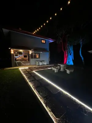 a house lit up at night with lights at Villazul 2 in Poás