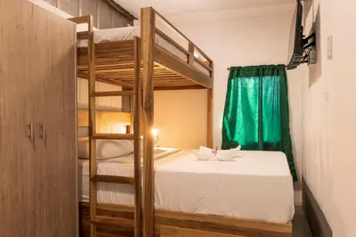 a bedroom with a bunk bed and a ladder at Emi’s Place Container Living in Uvita