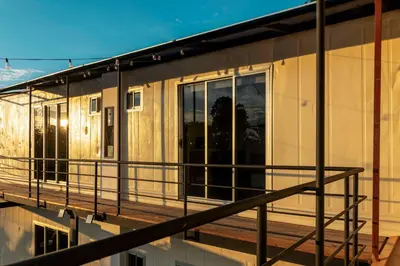 a house on a deck with glass doors at Emi’s Place Container Living in Uvita