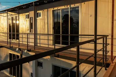 a balcony of a building with a house at Emi’s Place Container Living in Uvita