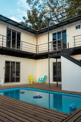a house with a swimming pool in front of it at Emi’s Place Container Living in Uvita
