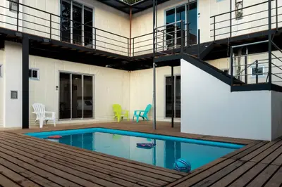a house with a swimming pool and a balcony at Emi’s Place Container Living in Uvita