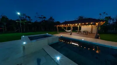 a swimming pool with a gazebo at night at Casa Roble Fortuna in Fortuna