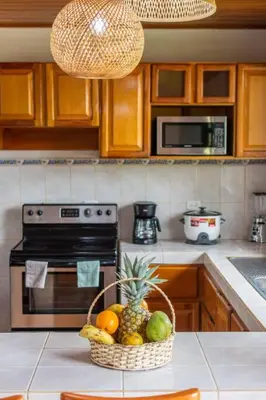 a kitchen with a basket of fruit on a counter at Casa Roble Fortuna in Fortuna