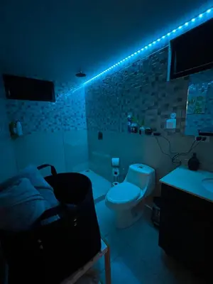 a dark bathroom with a toilet and a sink at Villazul 1 in Poás