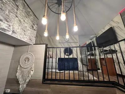 a room with a crib with a chair and lights at Villazul 1 in Poás