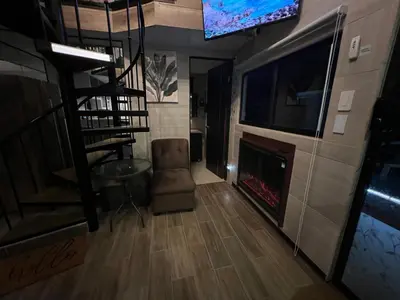 a living room with a fireplace and a flat screen tv at Villazul 1 in Poás