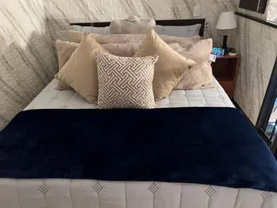 a bed with many pillows on it at Villazul 1 in Poás