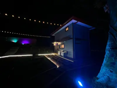 a house lit up at night with lights at Villazul 1 in Poás