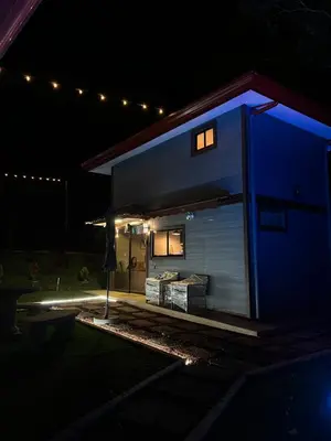 a house with a blue lit up facade at night at Villazul 1 in Poás