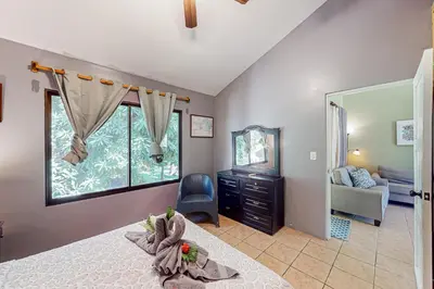 a bedroom with a bed and a chair and a mirror at Dolce Vita 7028 in Coco