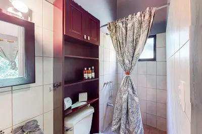 a bathroom with a toilet and a shower curtain at Dolce Vita 7028 in Coco