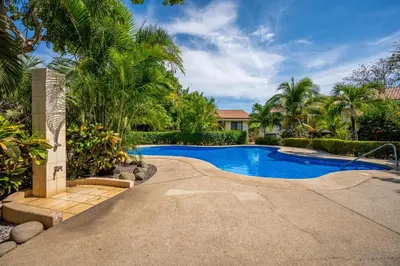 a swimming pool in a yard with palm trees at Dolce Vita 7028 in Coco