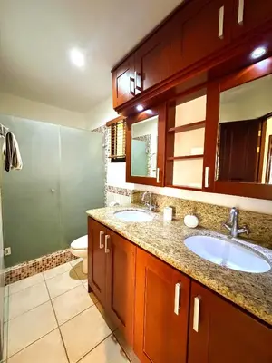 a bathroom with two sinks and a toilet at Breezy Paradise 2 bed2bath with mountain view in Coco