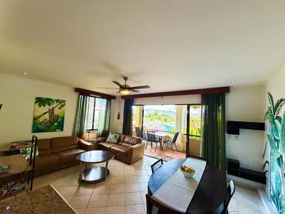 a living room with a couch and a table at Breezy Paradise 2 bed2bath with mountain view in Coco