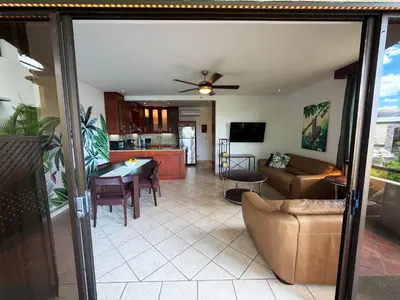 a living room and kitchen with a couch and a table at Breezy Paradise 2 bed2bath with mountain view in Coco