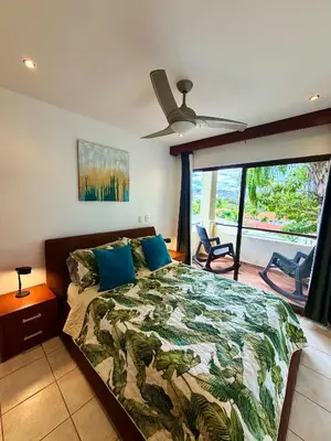 a bedroom with a bed and a ceiling fan at Breezy Paradise 2 bed2bath with mountain view in Coco
