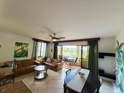 a living room with a couch and a table at Breezy Paradise 2 bed2bath with mountain view in Coco