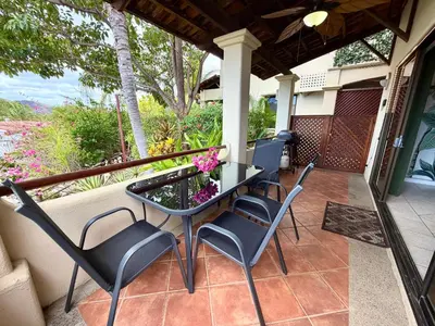 a patio with chairs and a table on a porch at Breezy Paradise 2 bed2bath with mountain view in Coco