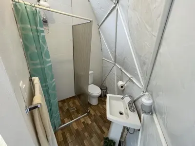 a small bathroom with a sink and a toilet at La Comarca River Glamping Dome near Manuel Antonio in Manuel Antonio