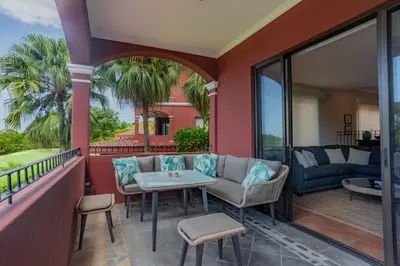 a balcony with a couch and a table and chairs at Serene 3BR Condo - Bougainvillea - Reserva Conchal Golf Resort in Playa Conchal