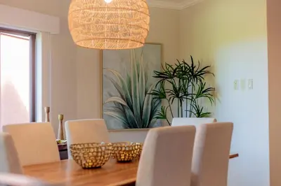 a dining room table with chairs and a light fixture at Serene 3BR Condo - Bougainvillea - Reserva Conchal Golf Resort in Playa Conchal