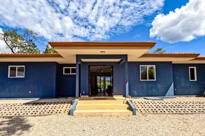a house with a blue wall at Casa El Sueño in Brasilito