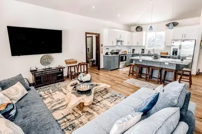a living room with a couch and a kitchen at Casa El Sueño in Brasilito